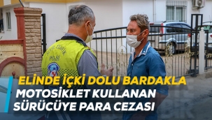 Elinde içki dolu bardakla motosiklet kullanan sürücüye para cezası